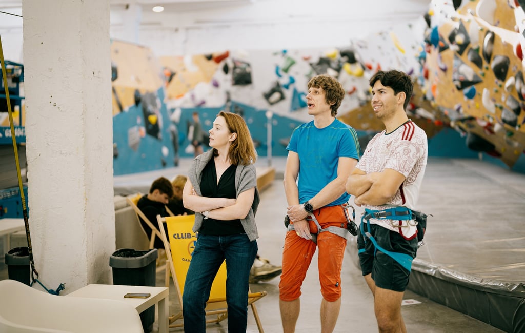 a group of people standing in climbing wall