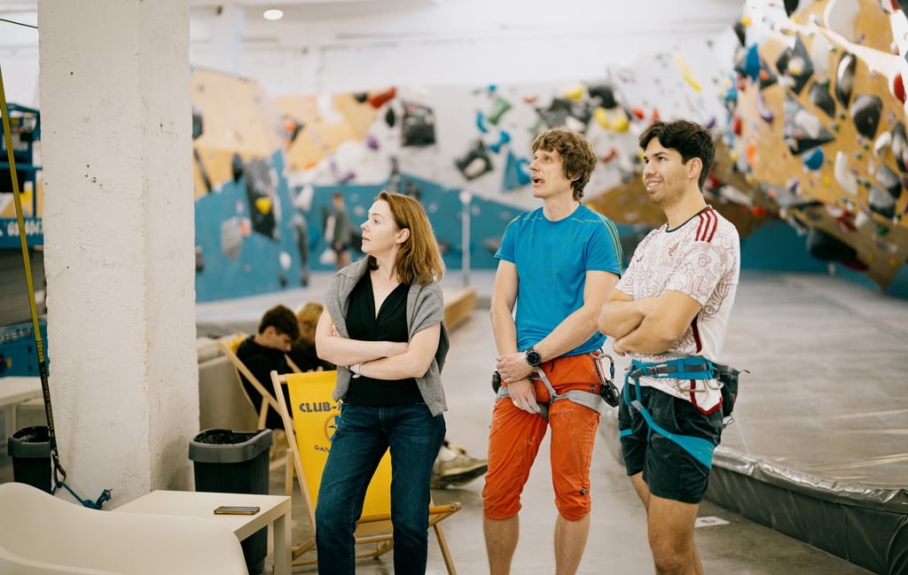 a group of people standing in climbing wall