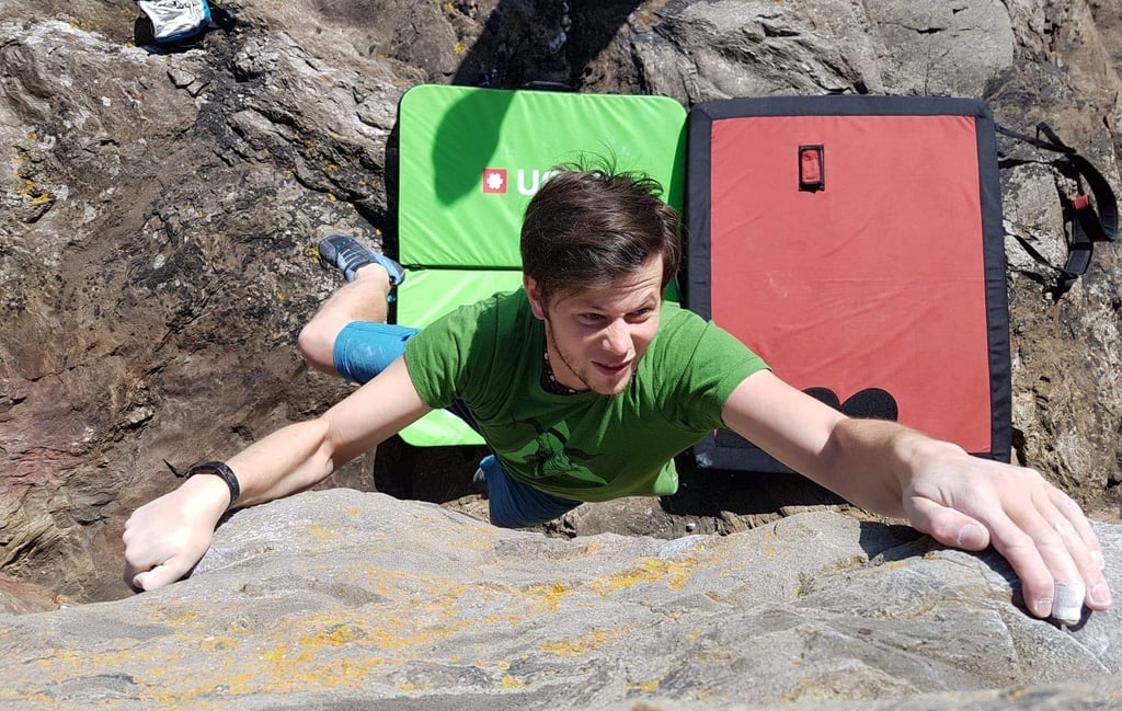 a man bouldering on a rock