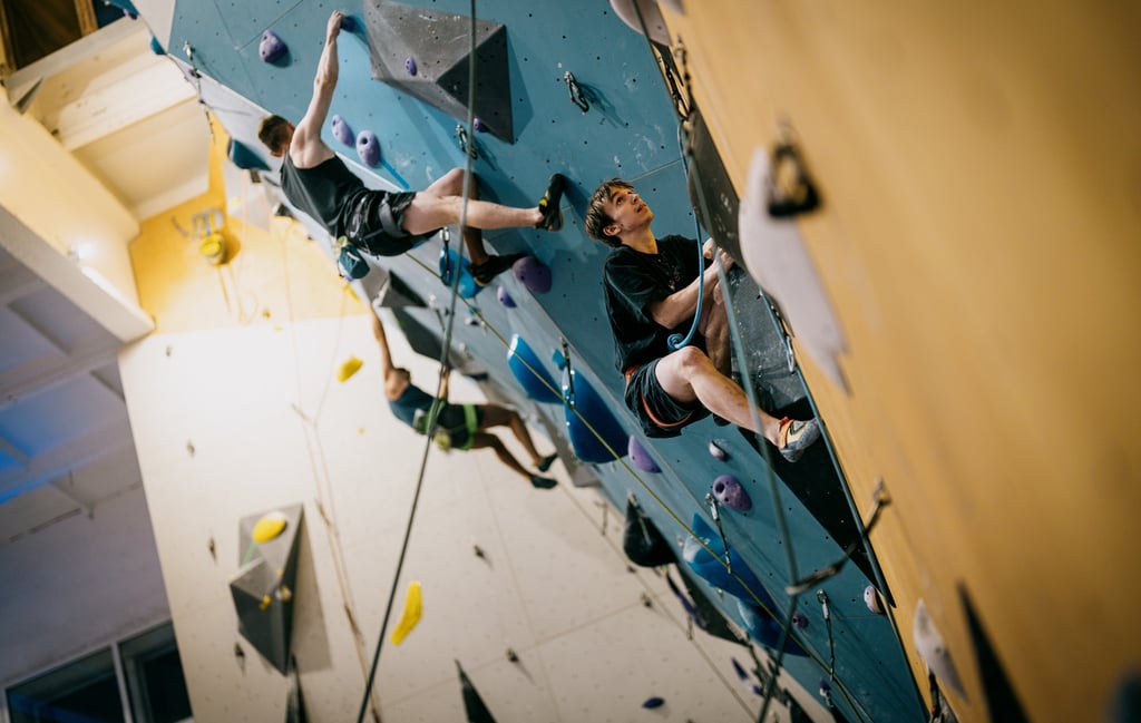 a man lead climbing on a climbing wall