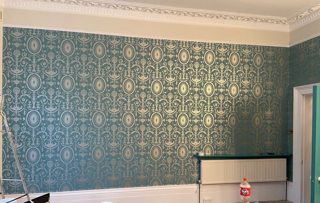 Elegant teal and gold damask wallpaper installed in a room n Sussex.
