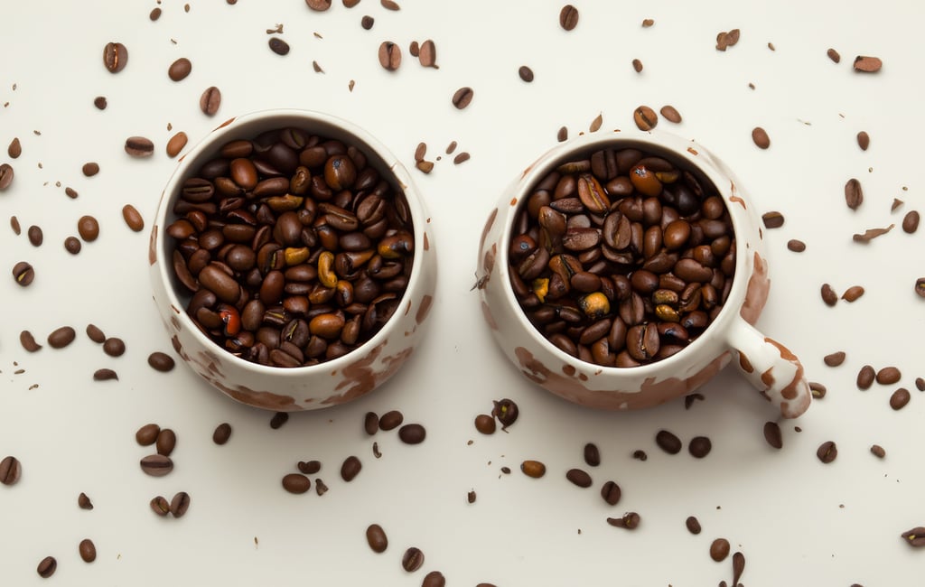 two cups of coffee beans and coffee beans