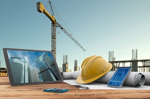 a tablet computer and a tablet with a construction helmet on top of it