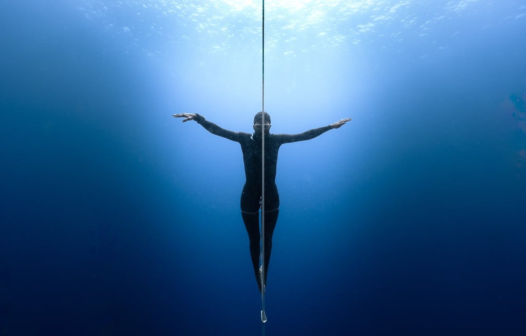 ethereal apnea athlete portrait underwater natural light by Laura Mommicchi