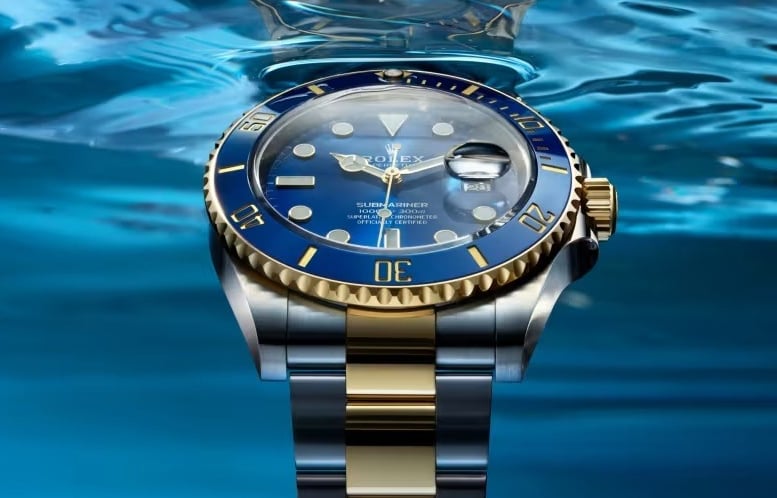 Rolex Submariner with a blue dial and gold accents, showcasing luxury and precision.