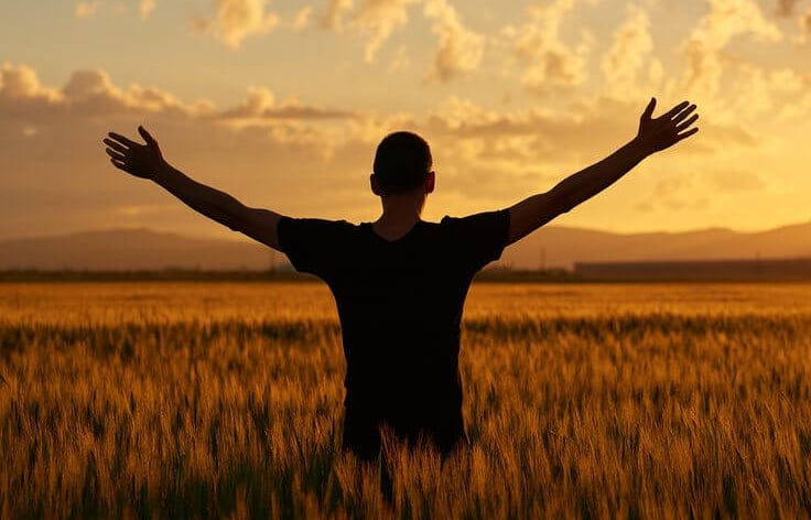 A person mindfully enjoying a sunset