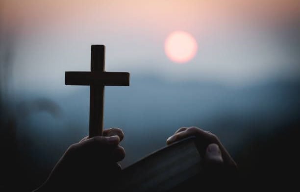 man holding a cross
