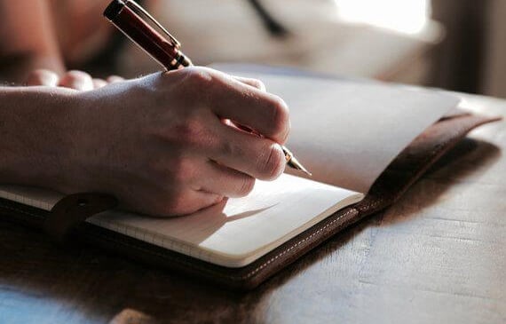A person setting goals in a planner.