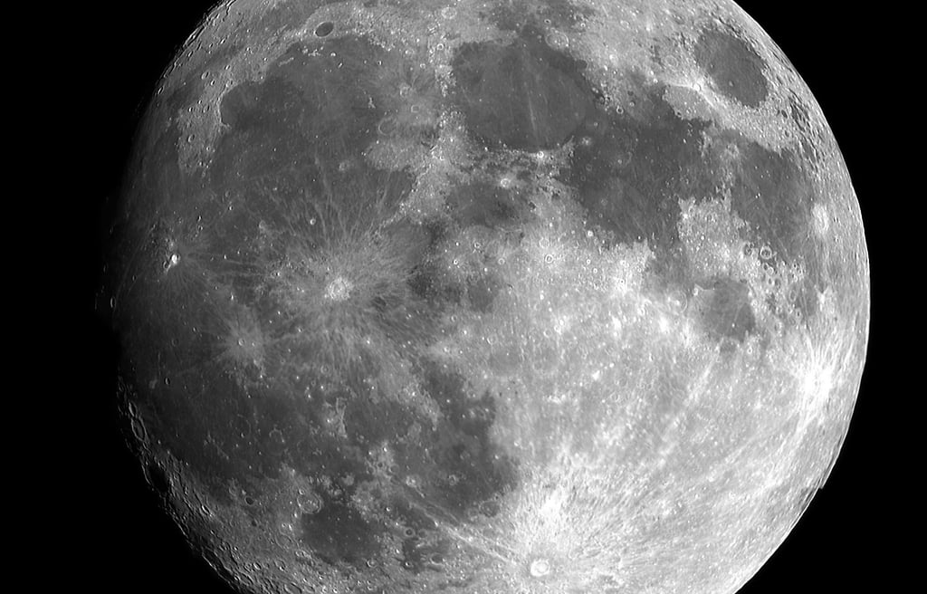 a clear large image of the moon illuminated against a black universe