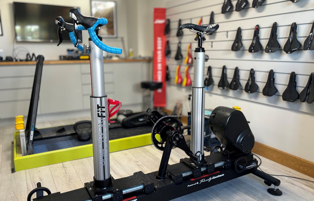 Professional bike fit using adjustable fit jig to assess rider position and alignment