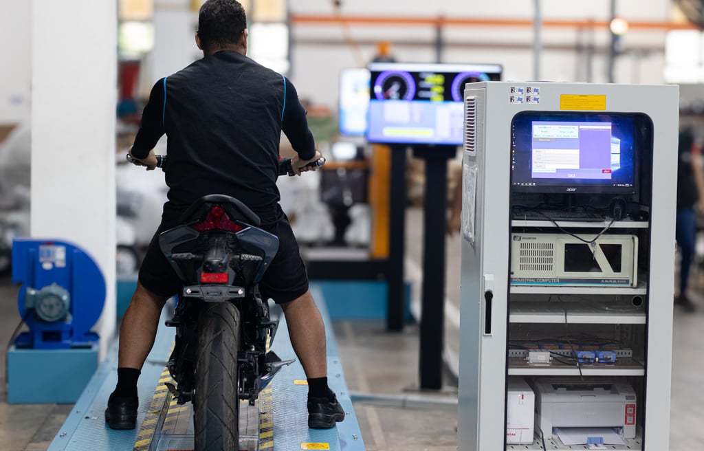 a man riding a motorcycle in a factory