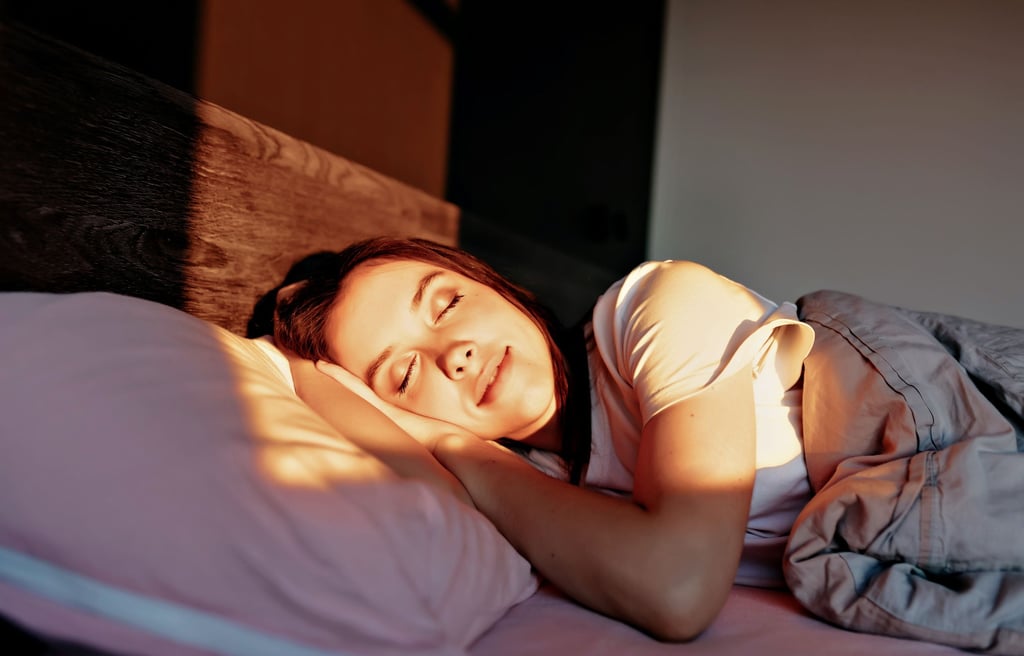 women with happy smile are sleeping in the bed in sunlight in modern apartment