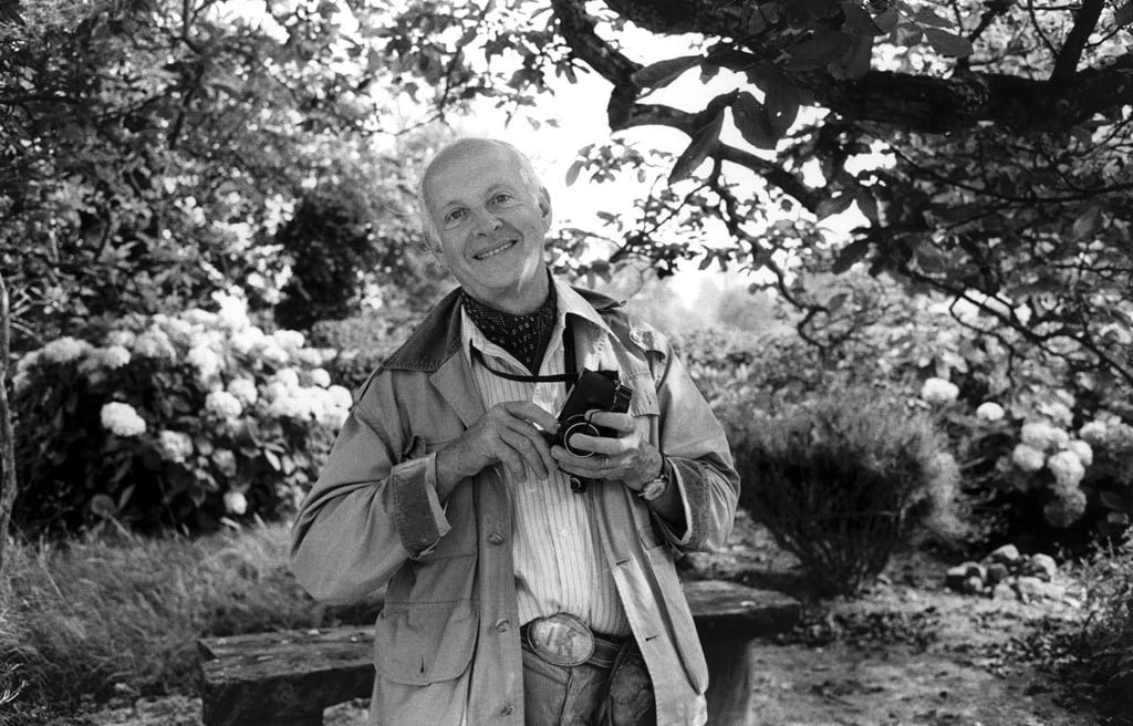 French photographer Henri Cartier-Bresson with his familiar Leica in a garden setting