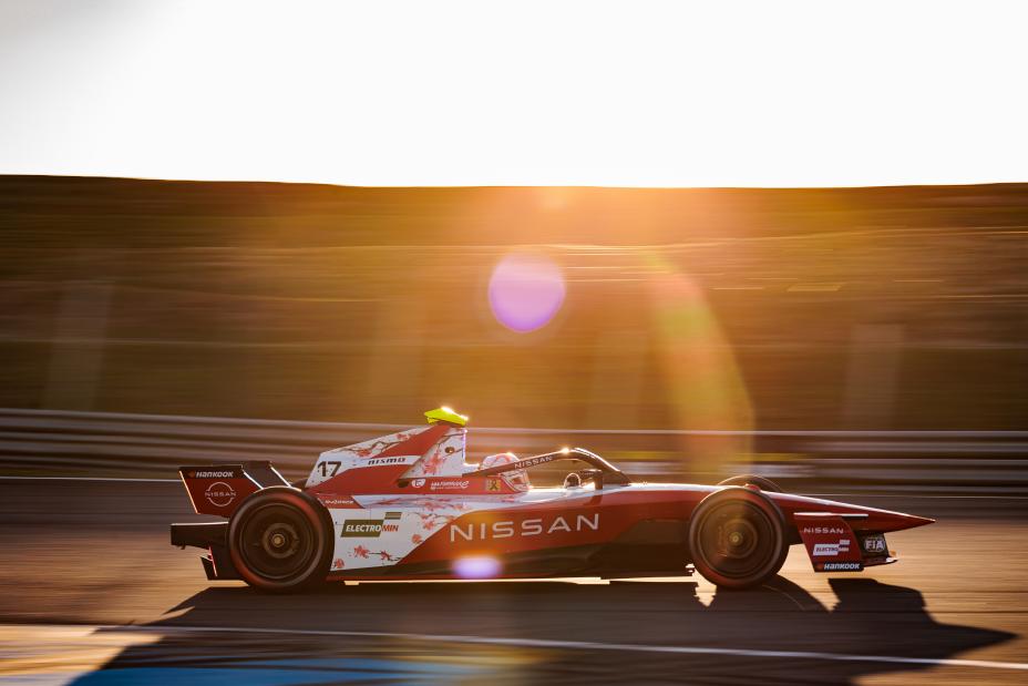 a man driving a Formula E race car on a track