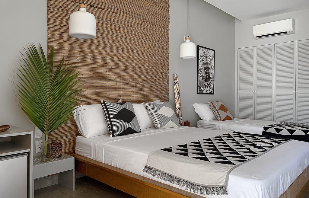 a bedroom with two beds and a television