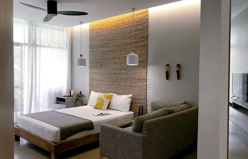 a bedroom with a couch and a bed