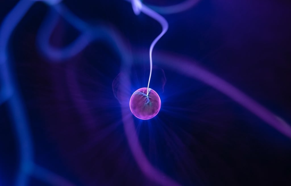 Purple ball irradiating electricity in a blue background.