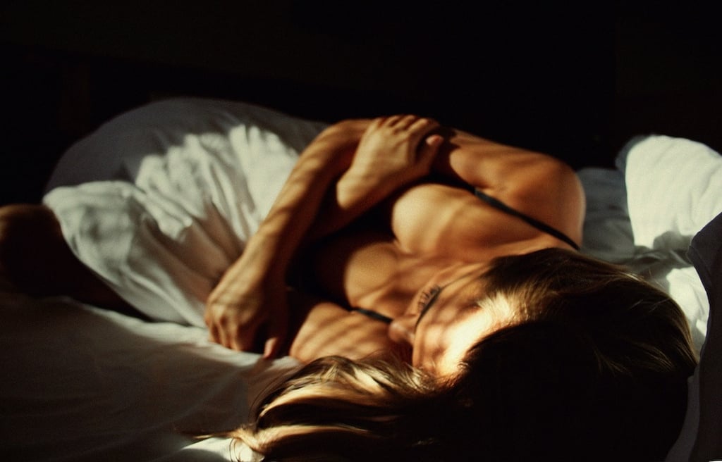 Woman in bed, suffering from dyspareunia.