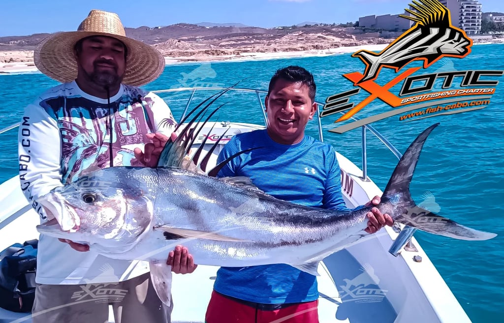 a man holding a fish fish on a boat