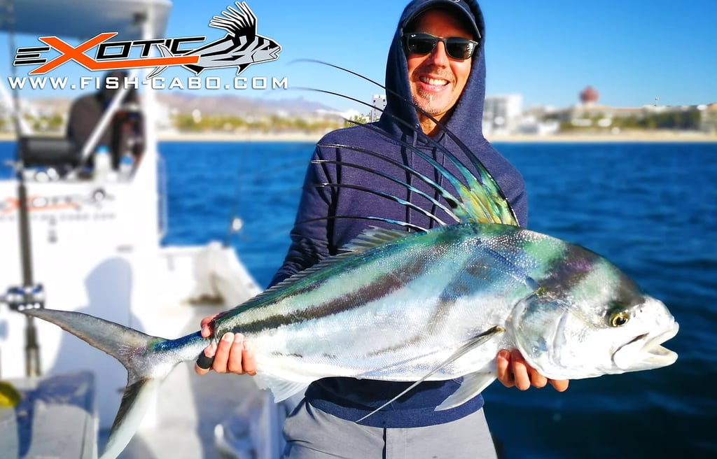 a man holding a fish fish on a boat