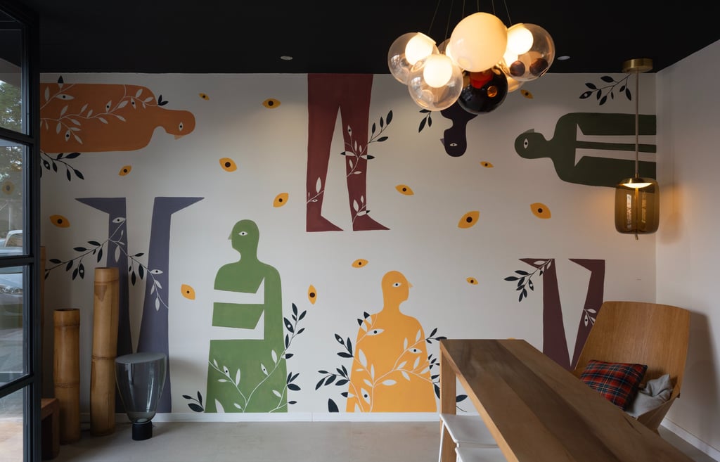 a wall mural of a woman sitting on a bench