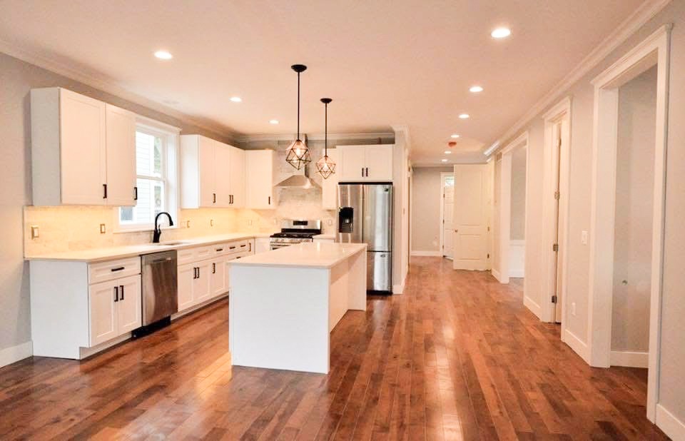 Custom upper and lower kitchen cabinets and island designed and built by Pearce Woodworks Detroit. 