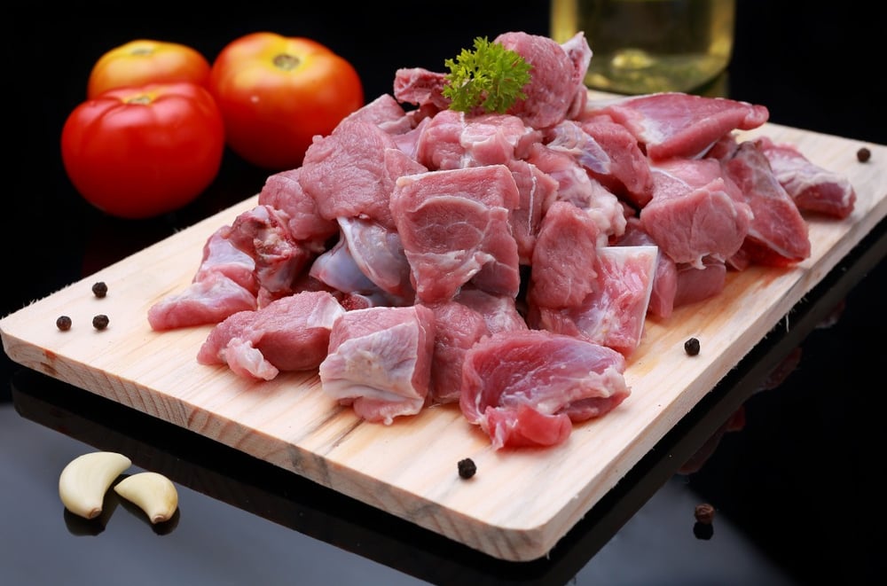 Fresh raw goat mutton on wooden board - high quality meat from Mutton Lovers.