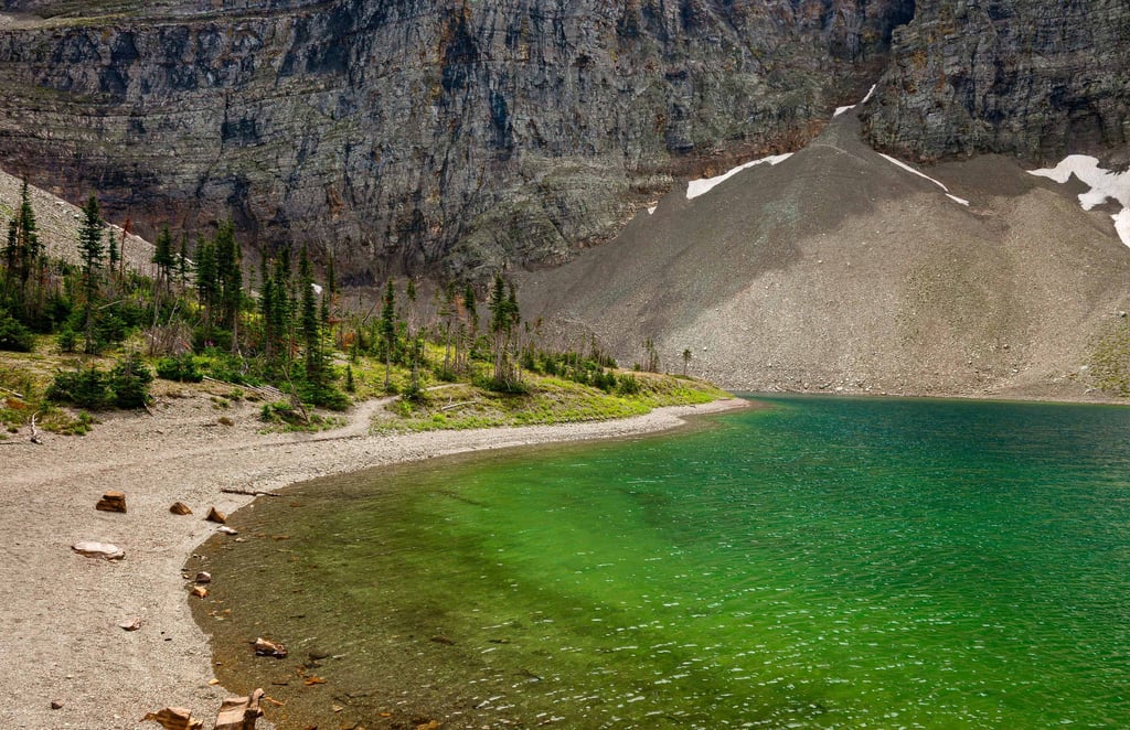 Emerald water at Crypt Lake surrounded by towering cliffs in Waterton Lakes National Park