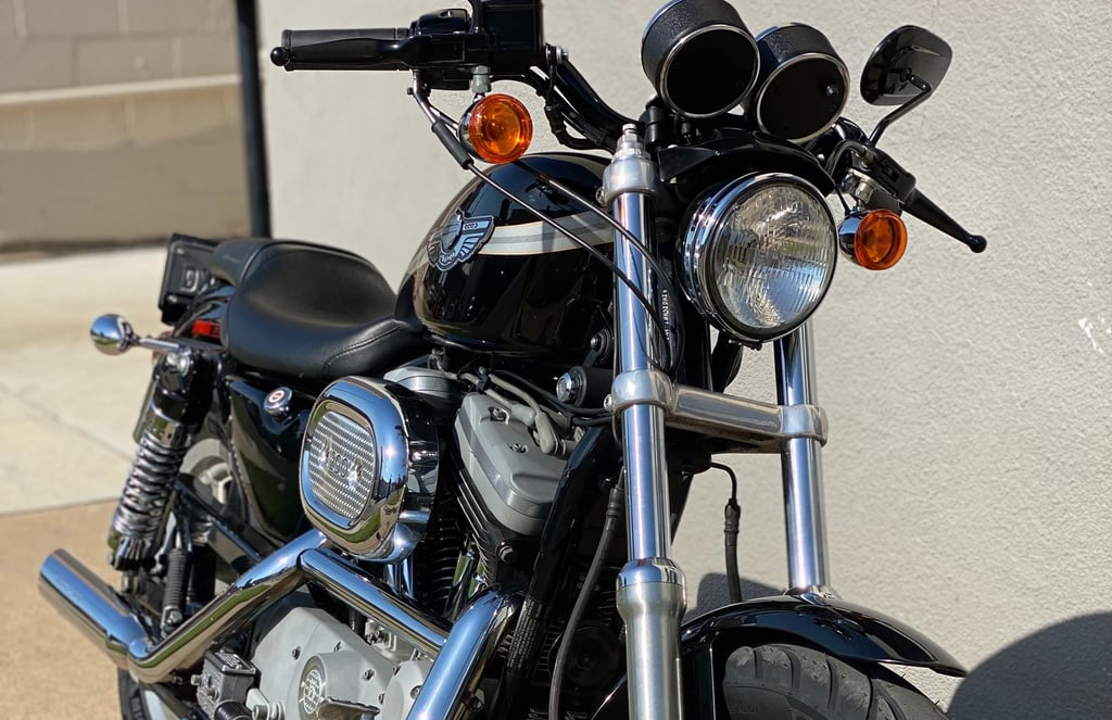 a motorcycle parked next to a building with a motorcycle