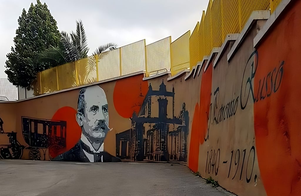 Mural dedicated to Italian historical figures, urban art created by Poliops with warm tones and arch