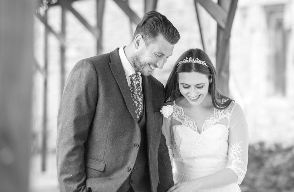 candid photo of bride and groom walking holding hands laughing and having a good time