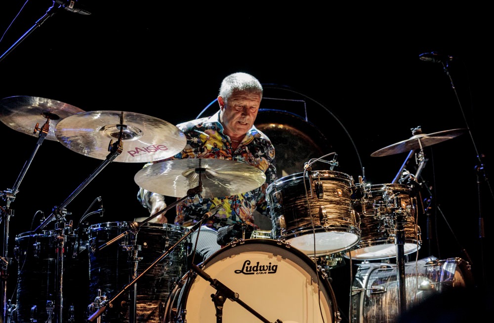 Registro fotográfico de Carl Palmer atrás de seu imponente kit de bateria.
