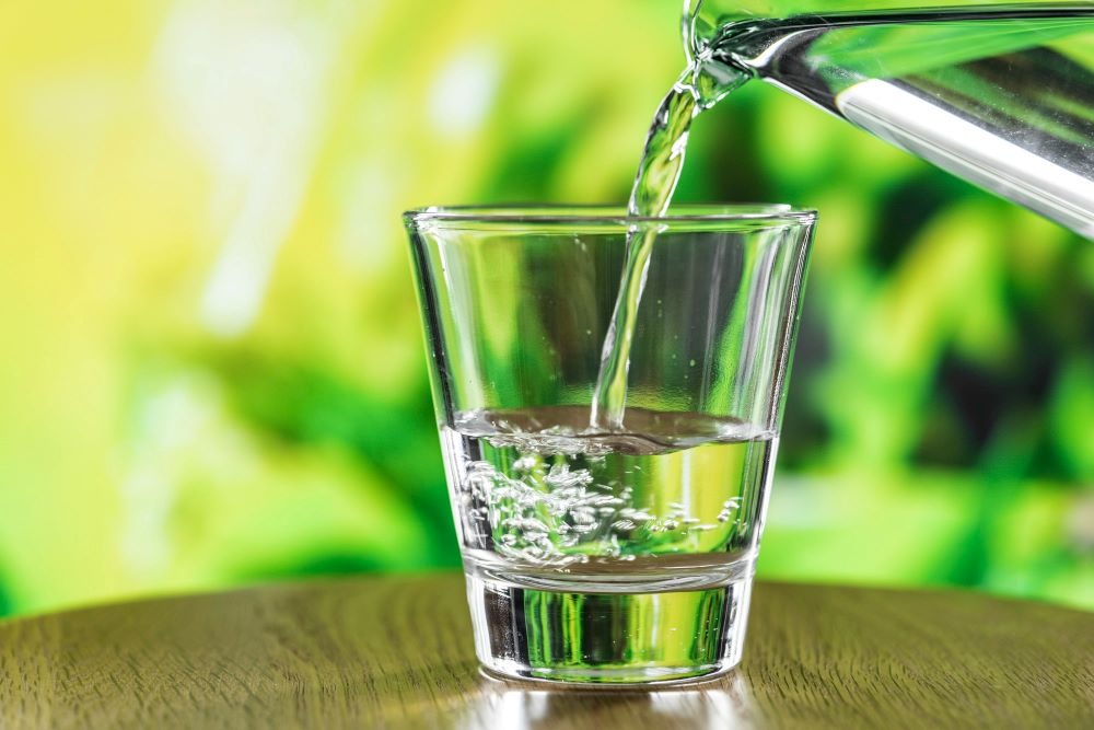 a glass of water is being poured