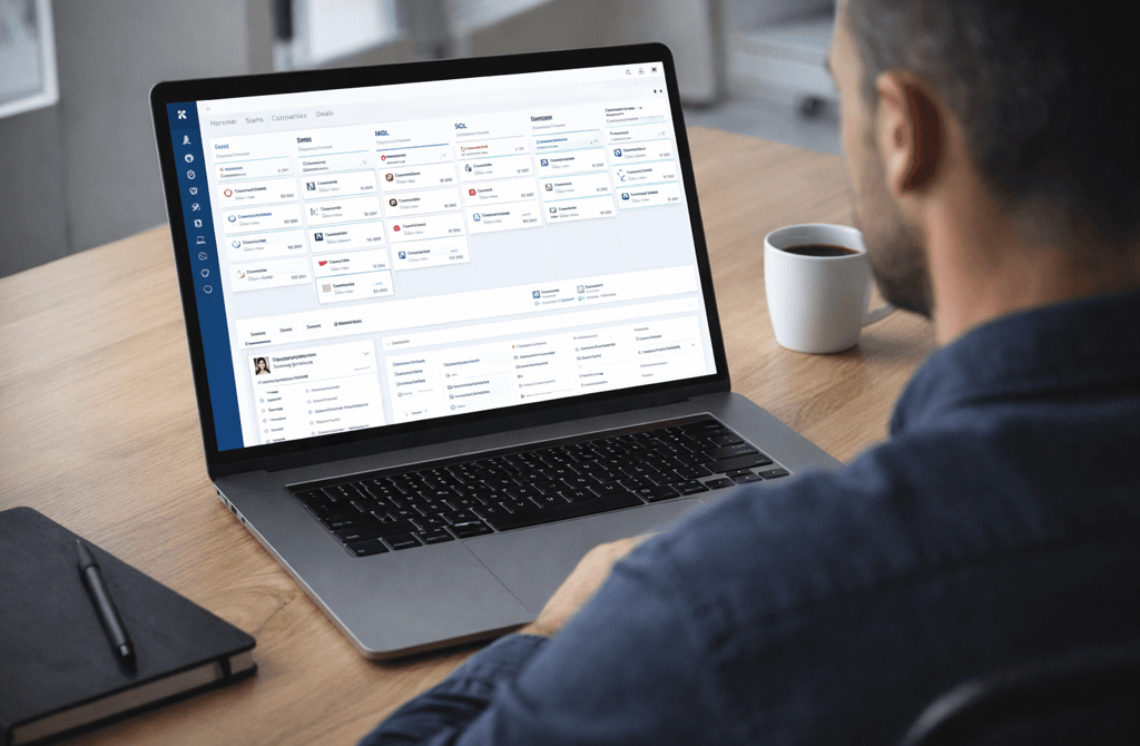 Founder reviewing a clean CRM dashboard on a laptop in a modern office