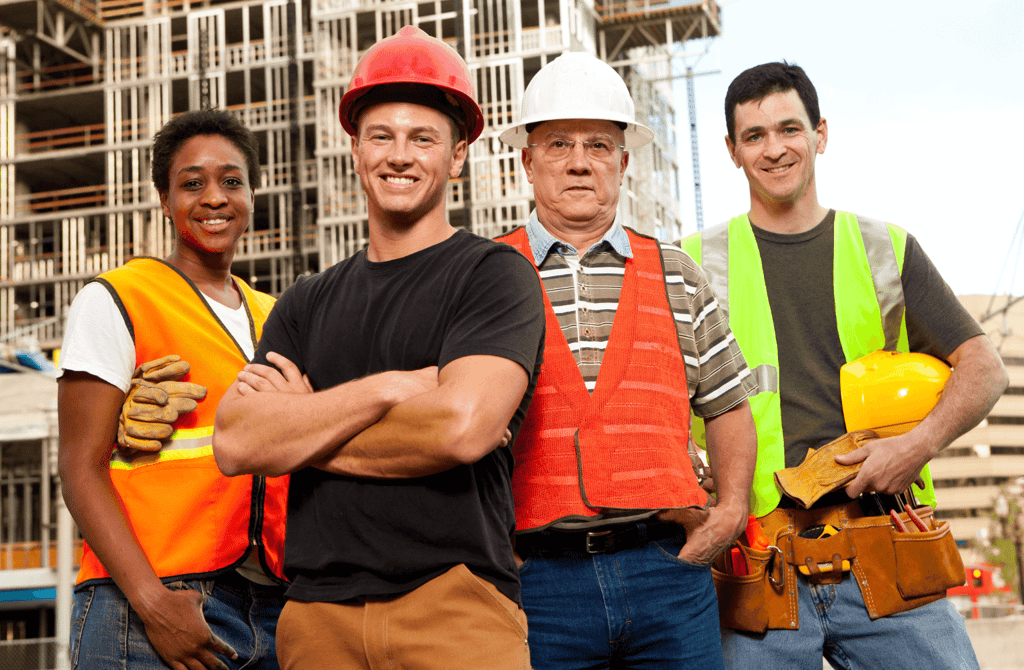 Construction workers in safety gear at an active building site