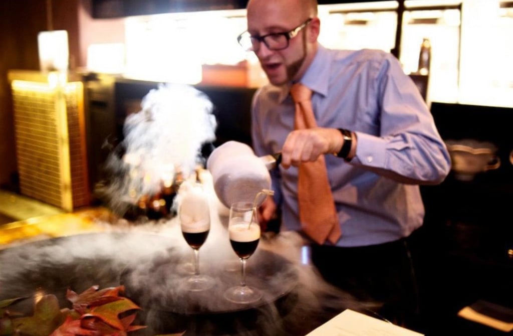 a man in a tie and shirt making molecular cocktails