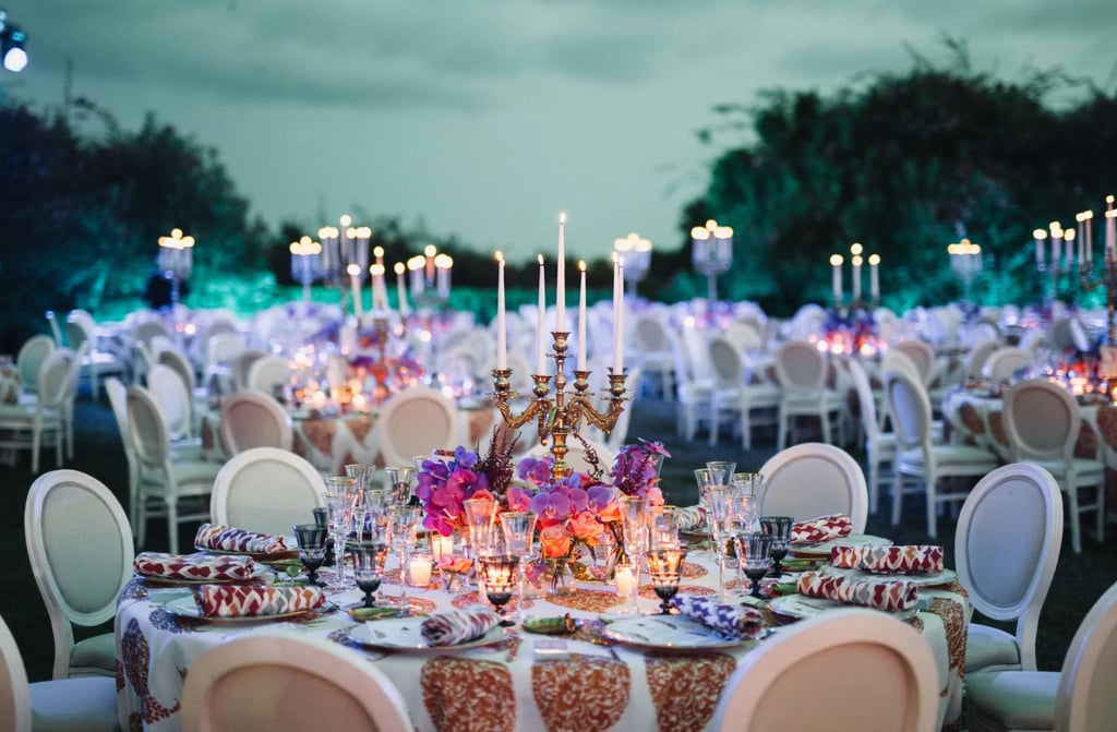 Outdoor reception setup at dusk with floral centerpieces