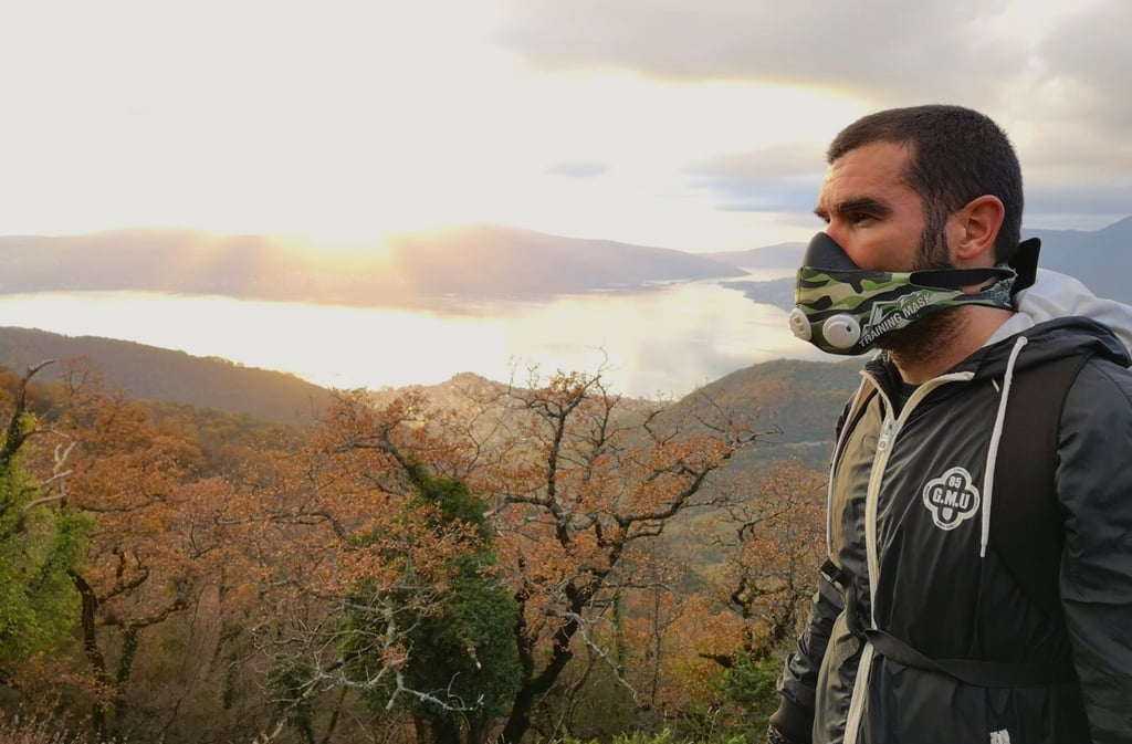 a man wearing a mask and a mask on a mountain