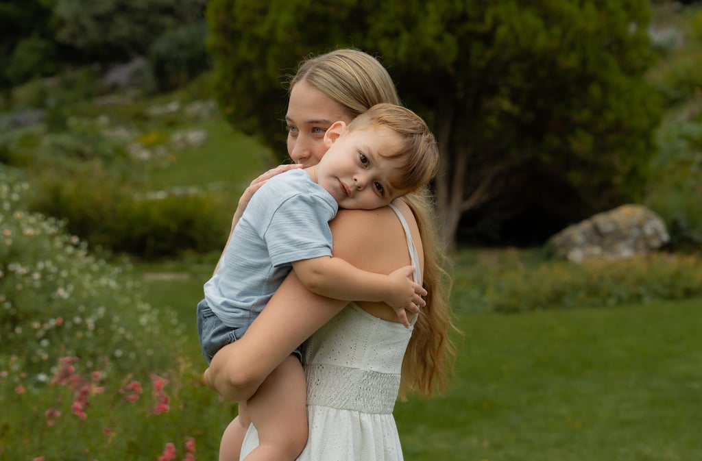 Mother holding her son in the park