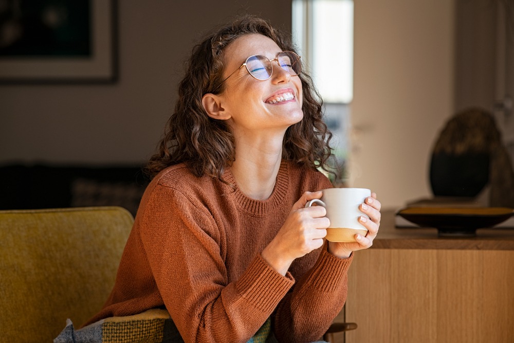 Lady who is taking the time to appreciate what  she has in life and is smiling.