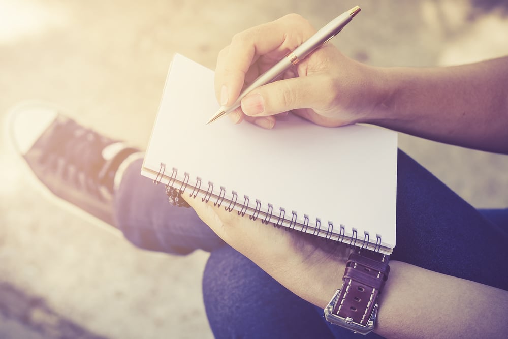 Person writing their personal growth goals