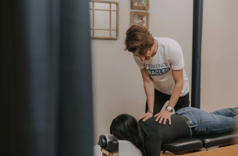 Pregnant woman receiving gentle prenatal chiropractic adjustment in Franklin TN
