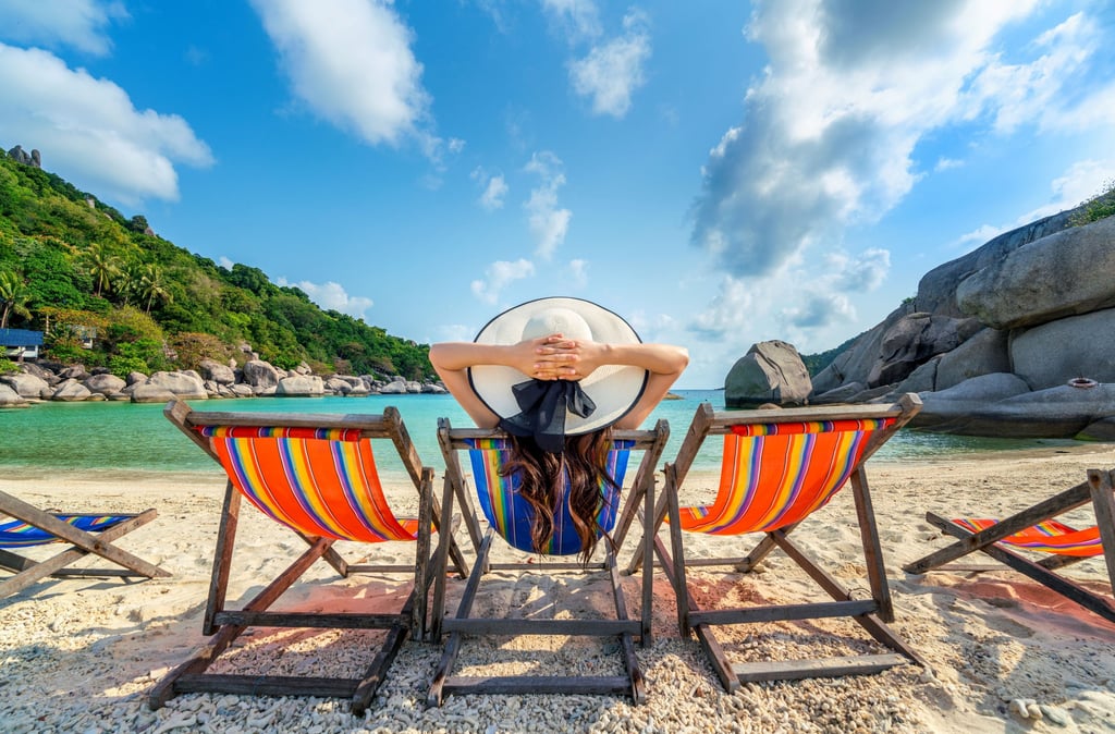 a woman sitting in a chair with her hands on her head