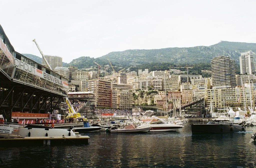 a harborfront of a city with a bridge over the water