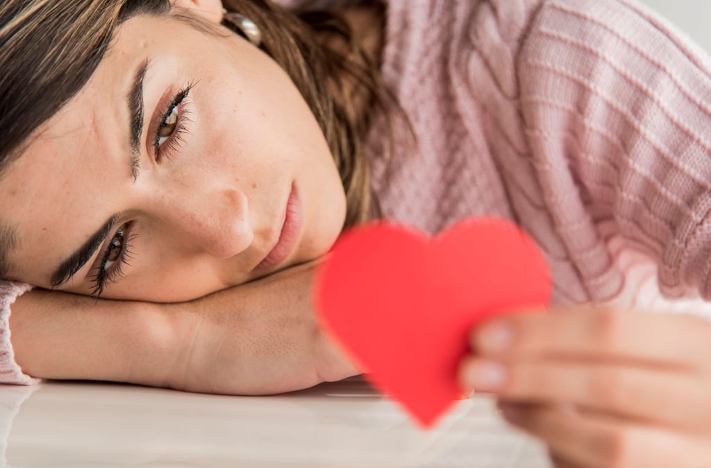 a woman holding red heart in her hand