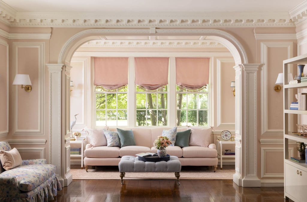 a living room with a couch and a ottoman