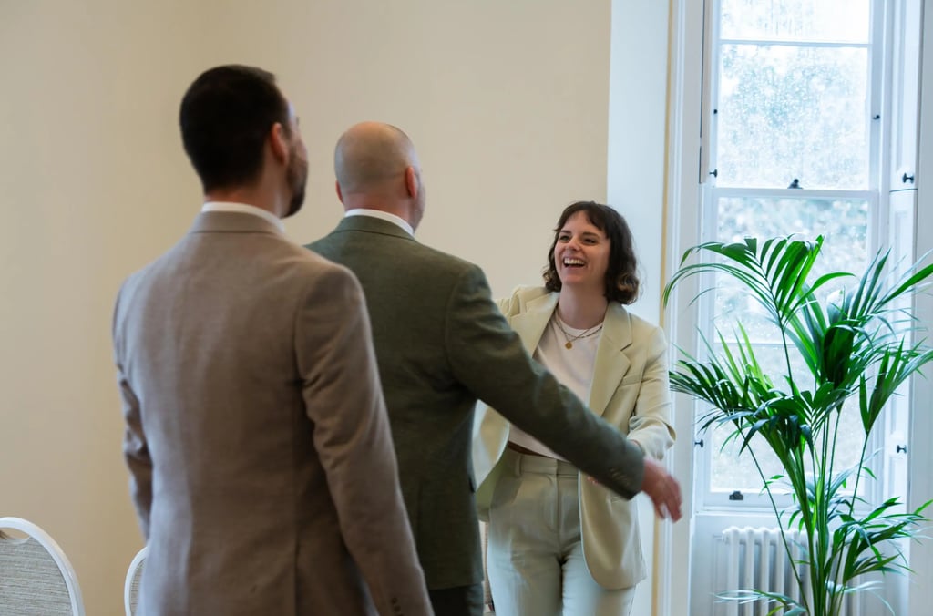 two men  and woman standing in a room