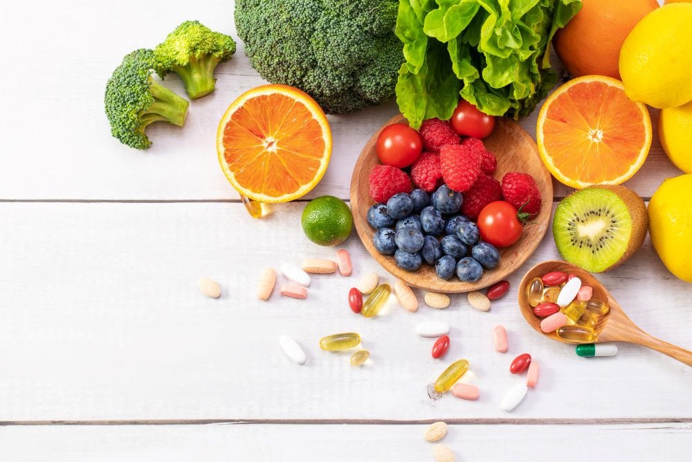 a variety of fruits, vegetables and vitamins on a table