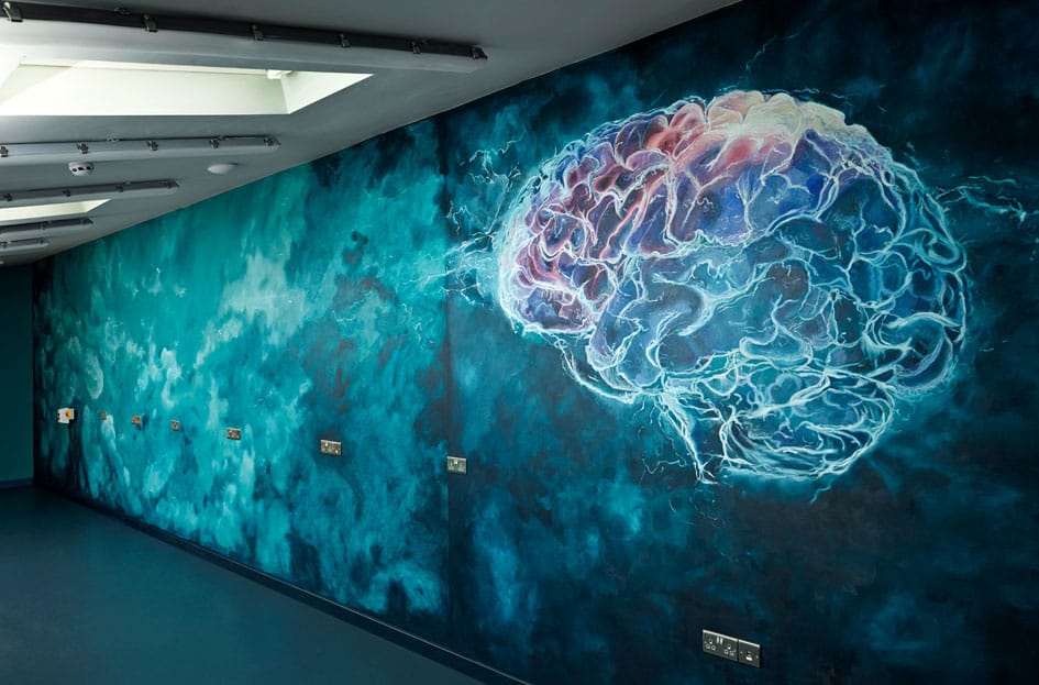  A vibrant brain logo spans the wall, embodying the spirit of creativity and continuous brainstorming in a Cambridgeshire R&D