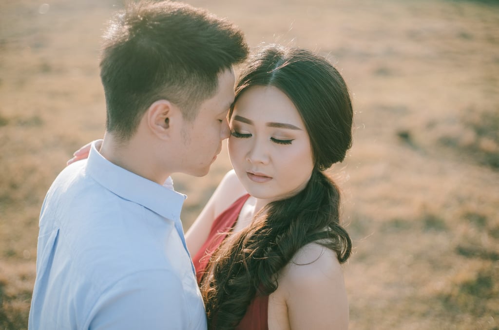 Close emotional portrait of intimate couple during sunset at Pantai Nyanyi Bali.